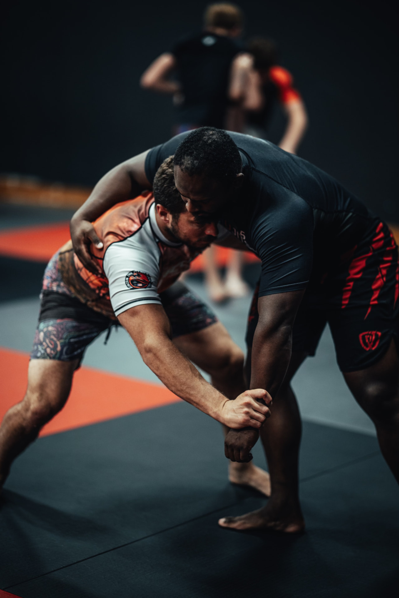 Two grapplers battling for a clinch and underhook during wrestling drills