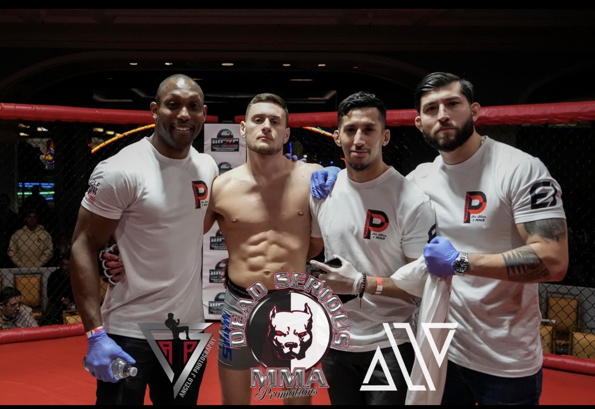 Pressure coaching staff in team shirts standing with their fighter in the ring after the bout