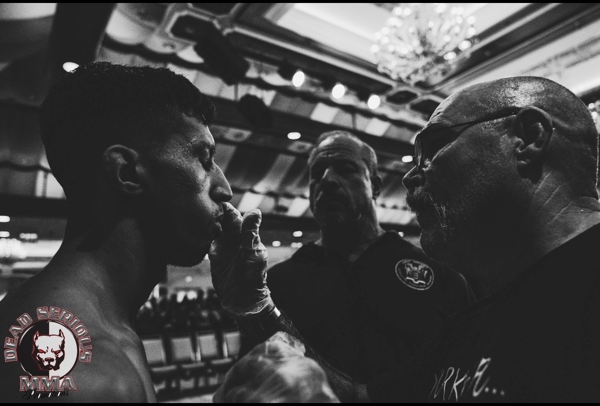 Coach giving instructions to a fighter between rounds in the corner of the ring